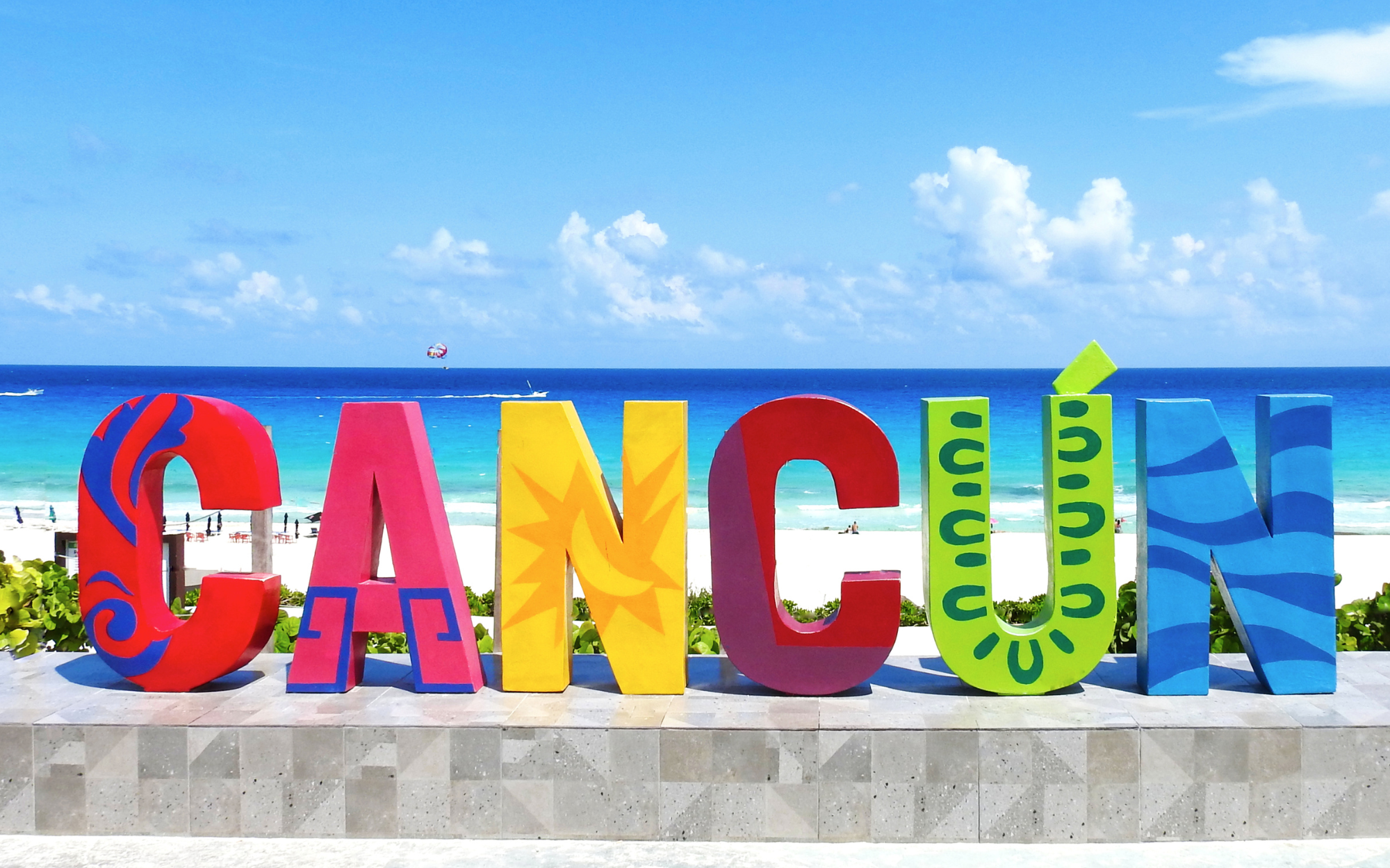 Cancun sign in Mexico with the beach in the background