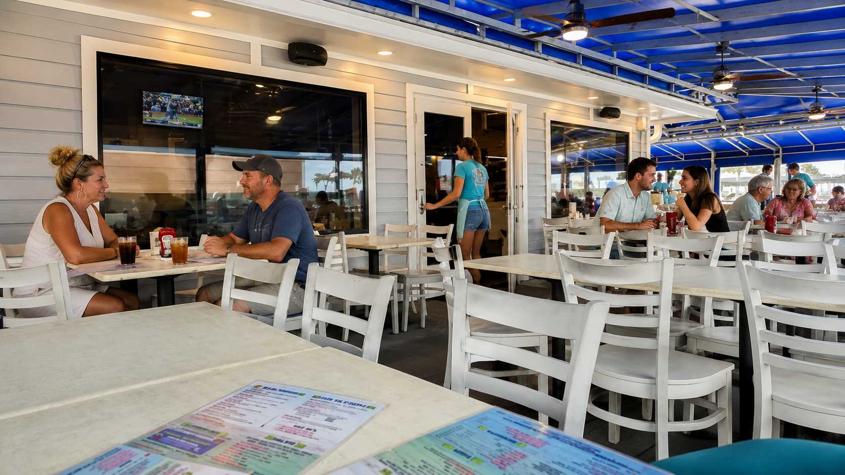 People sitting on a patio on Gulf Shores Beach