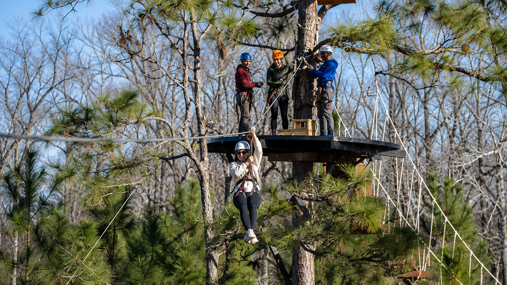 people ziplining at Hummingbird Zipline Course in Orange Beach