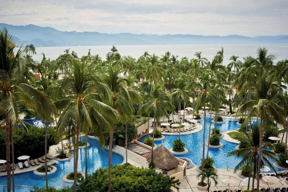 Resort pool and plenty palm trees