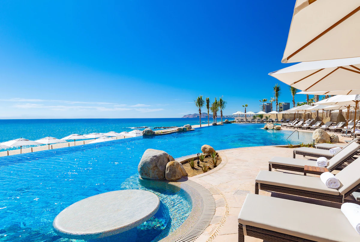 Pool side seating with umbrellas and ocean view
